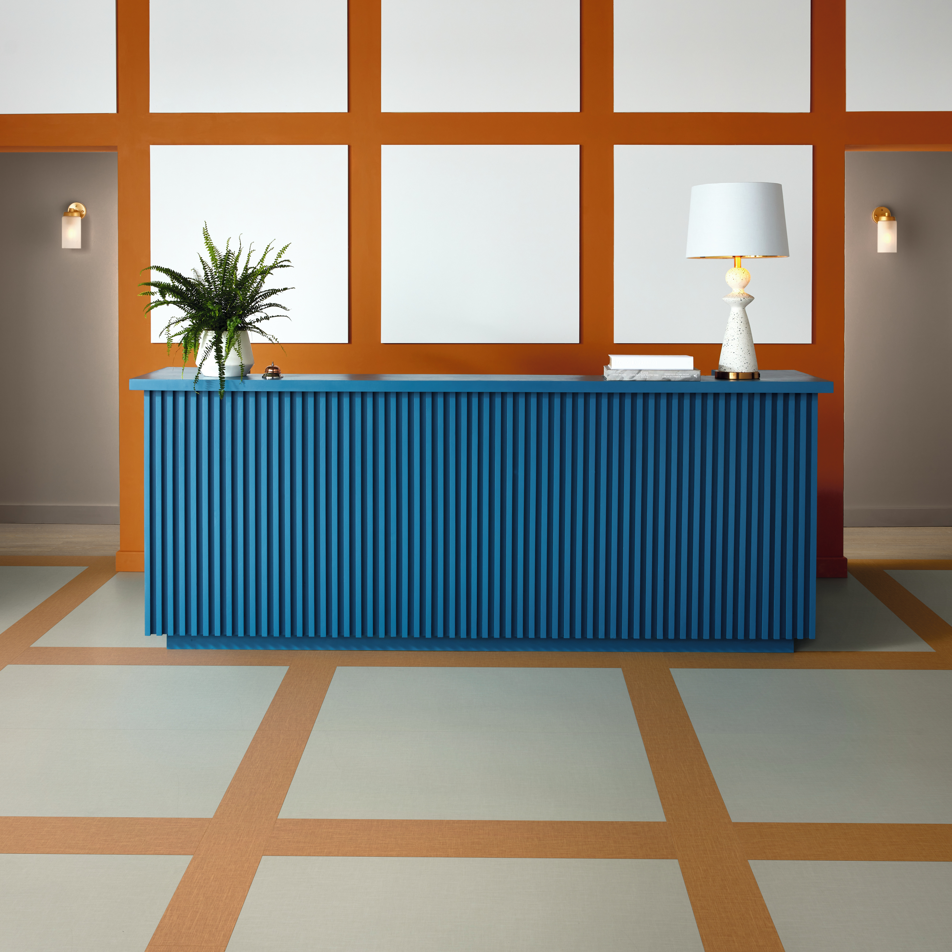 Reception desk with Amber SP721 and Zinc SP723 floors in a block pattern matching the wall